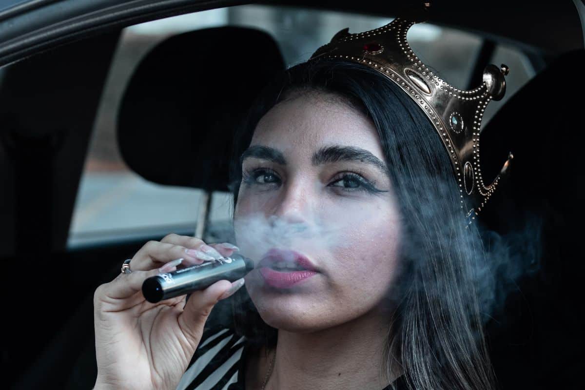 A lady vaping delta 9 inside a car